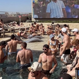 people socializing outside in a pool