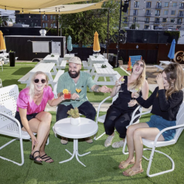 people laughing at tables outdoors