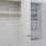 a white cabinet with a shelf and a mirror