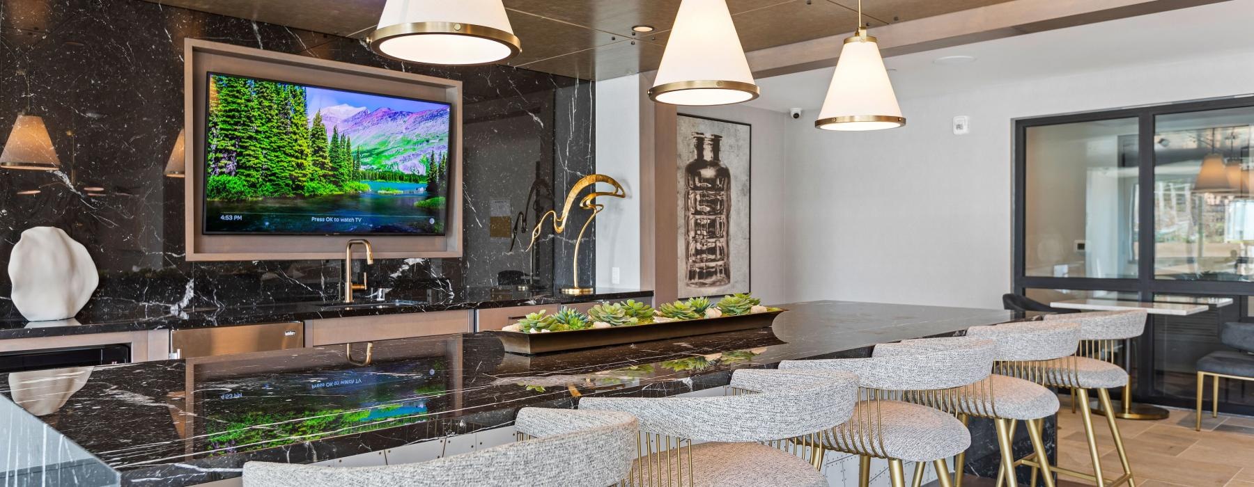 a bar with a tv and chairs