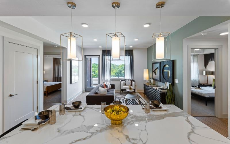 a large living room with a large glass table